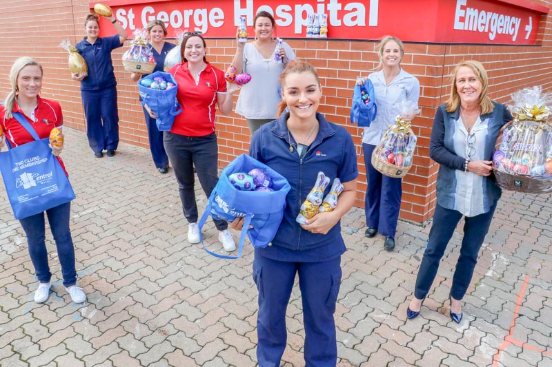 St George Hospital staff standing in front of the hospital, holding easter eggs 