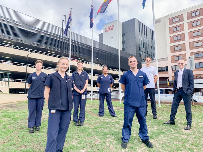 New nurses standing in front of St George Hospital with General Manager, Paul Darcy