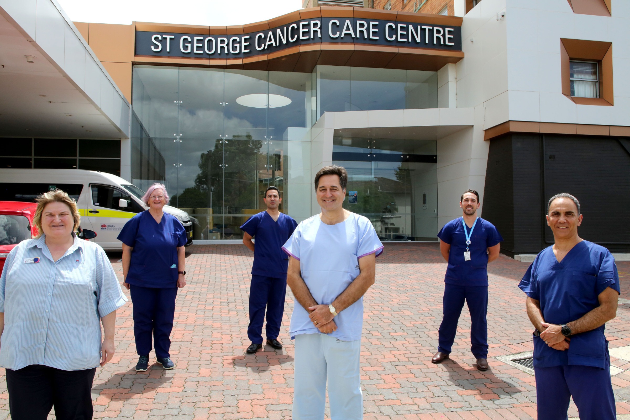 Staff standing in front of the Cancer Care Centre 