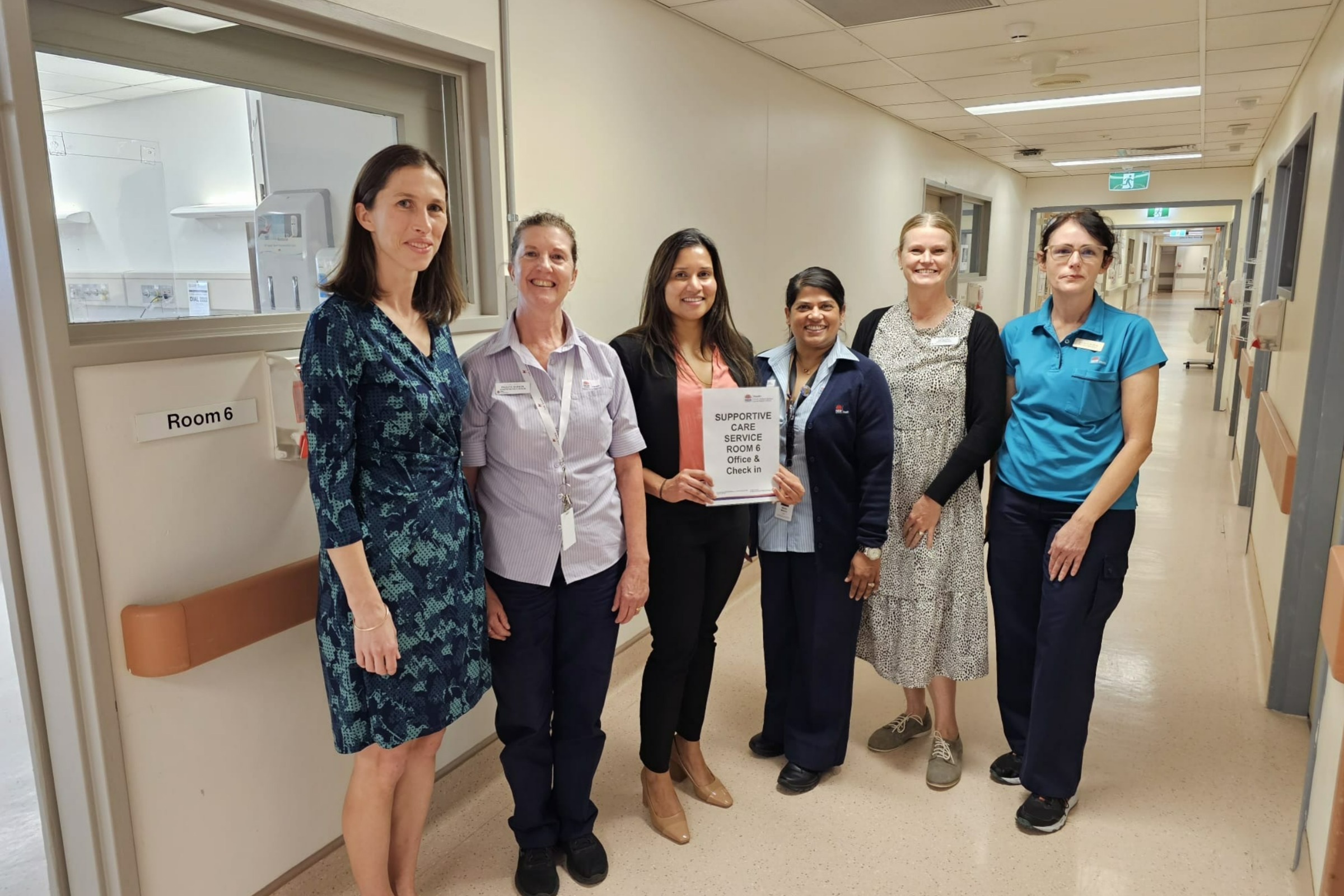 A multidisciplinary team at St George Hospital standing in a corridor