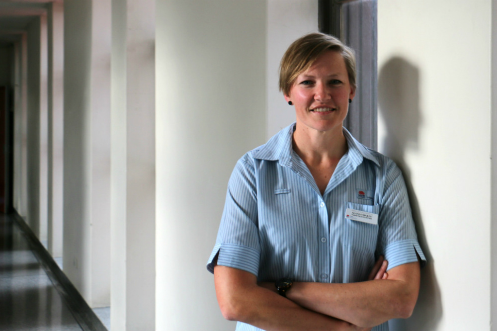 Nurse leaning on wall