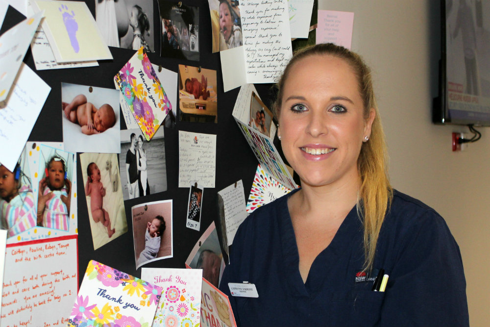 Nurse in front of notice board