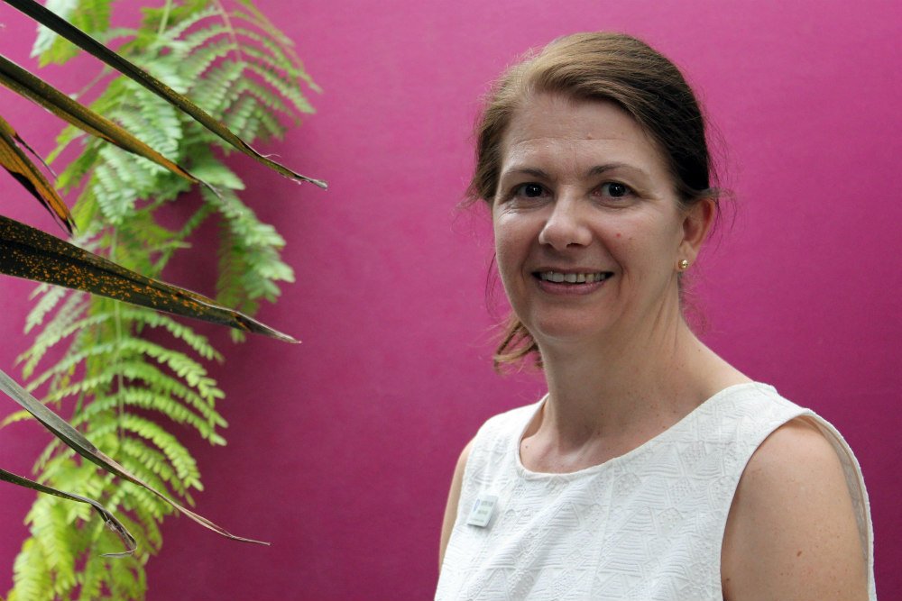 Lady in front of pink wall