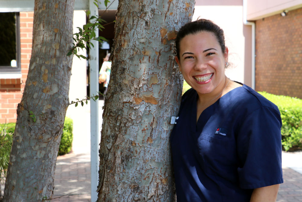 Woman leaning on tree