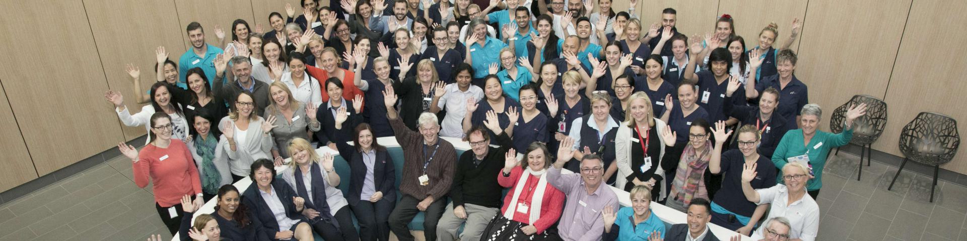 Group of staff waving