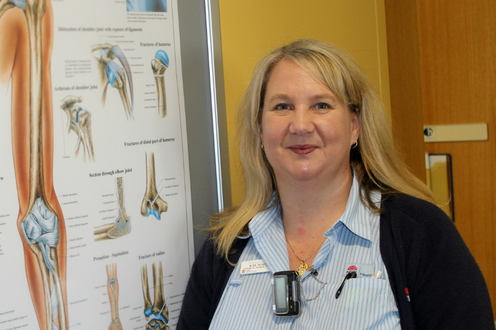 Nurse in front of poster