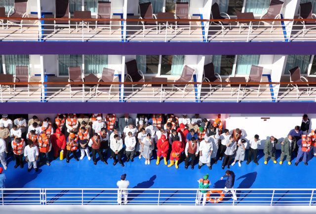 Cruise ship crew on deck. The Australian Biosecurity Act 2015 requires that ship report any death or any traveller who has one or more signs or symptoms of a listed human disease to a Biosecurity Officer.  