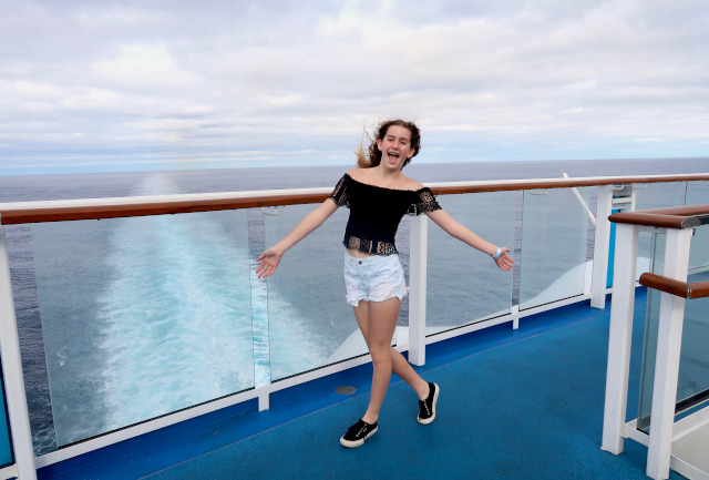 Girl on cruise ship deck.Cruise ships have become a popular mode of holiday travel, attracting large numbers of people from all over the world.