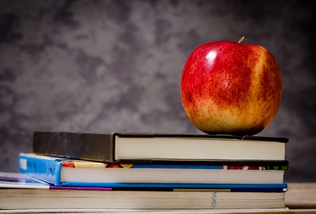 apple on book stack. Provides general advice to schools about our school vaccination program