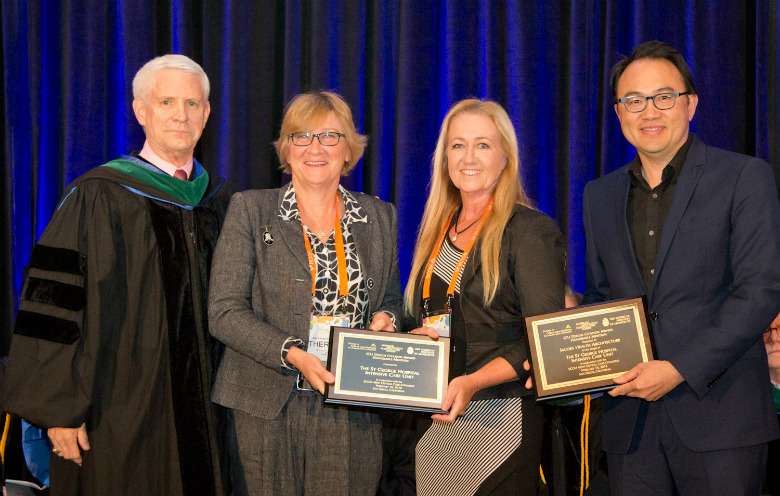 Group of four people receiving awards