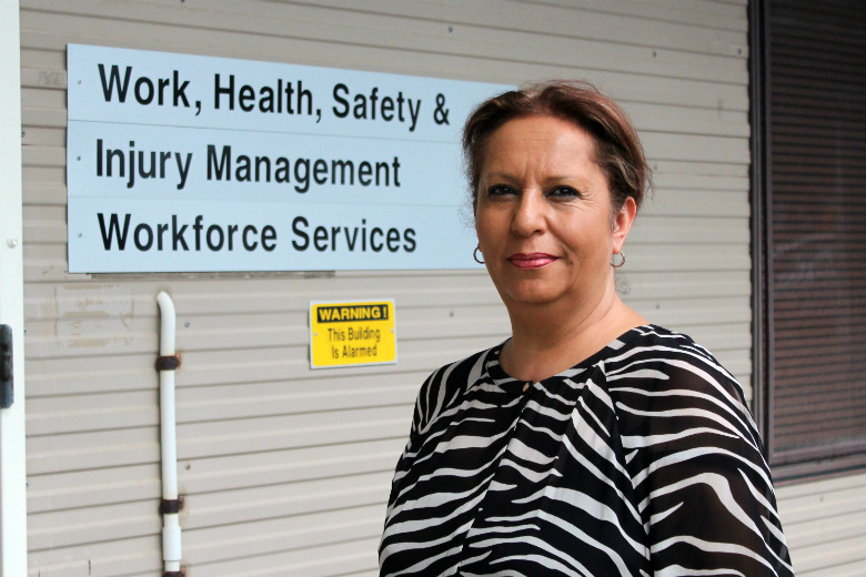 Lady standing in front of Workforce Services sign 