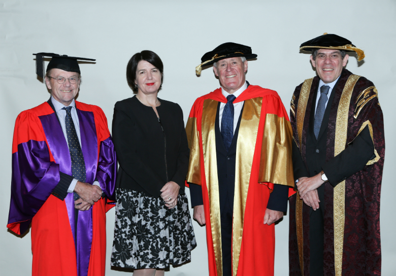 Group of four people in university awards setting