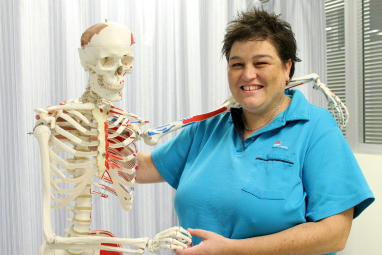 Woman with arm around teaching skeleton 