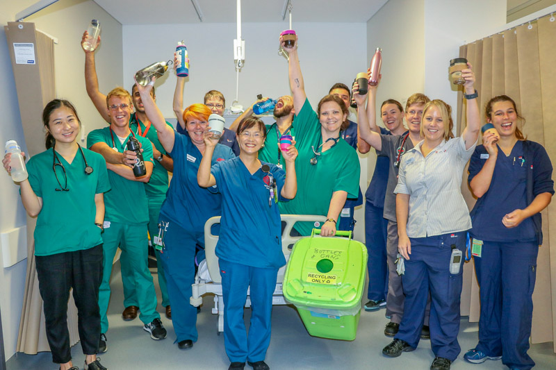 St George Hospital's "Green Dragons" showing off their green bin, Keep Cups and sustainble water bottles 