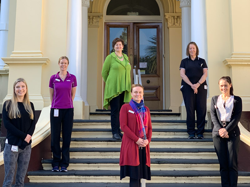 Staff involved in the Wellness Check program standing outside War Memorial Hospital 