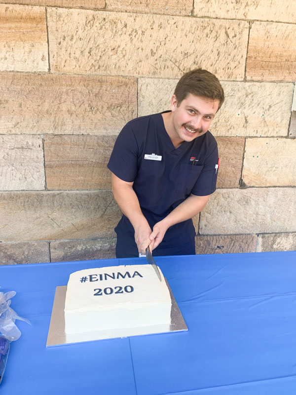 Corey Sclater cutting a cake 