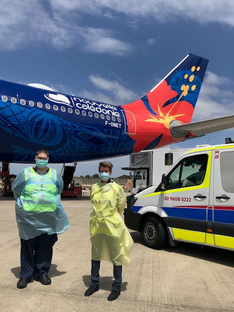 Staff standing on the tarmac next to the plane 