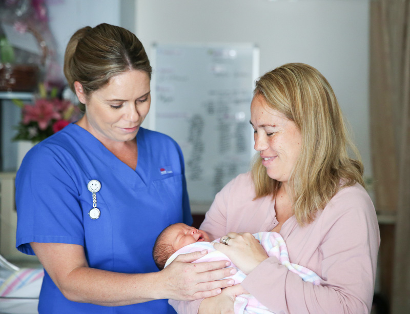Midwife, mother and newborn baby