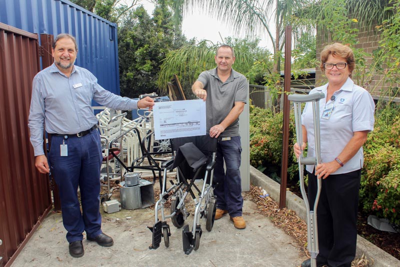 Calvary Health Care Kogarah staff with a copy of their latest cheque from the InfraBuild Recycling and some metal objects ready for recycling