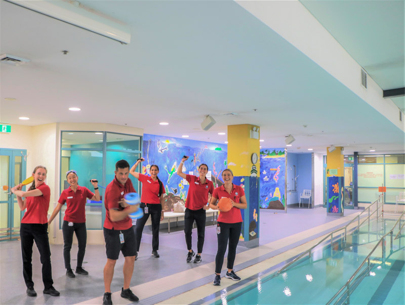 Physiotherapy staff in front of pool  