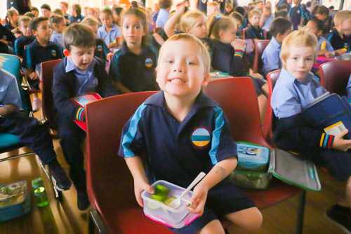 School children eating vegetables