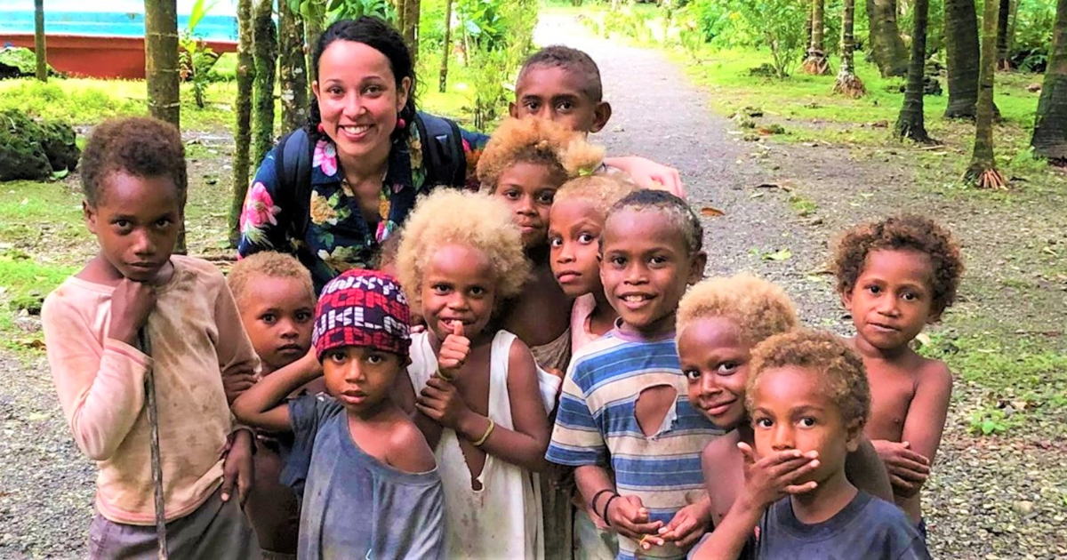 Dr Marianne Gale surrounded by children 