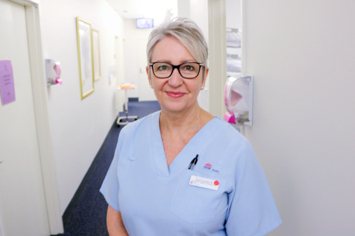 Ellen standing in a hospital ward 