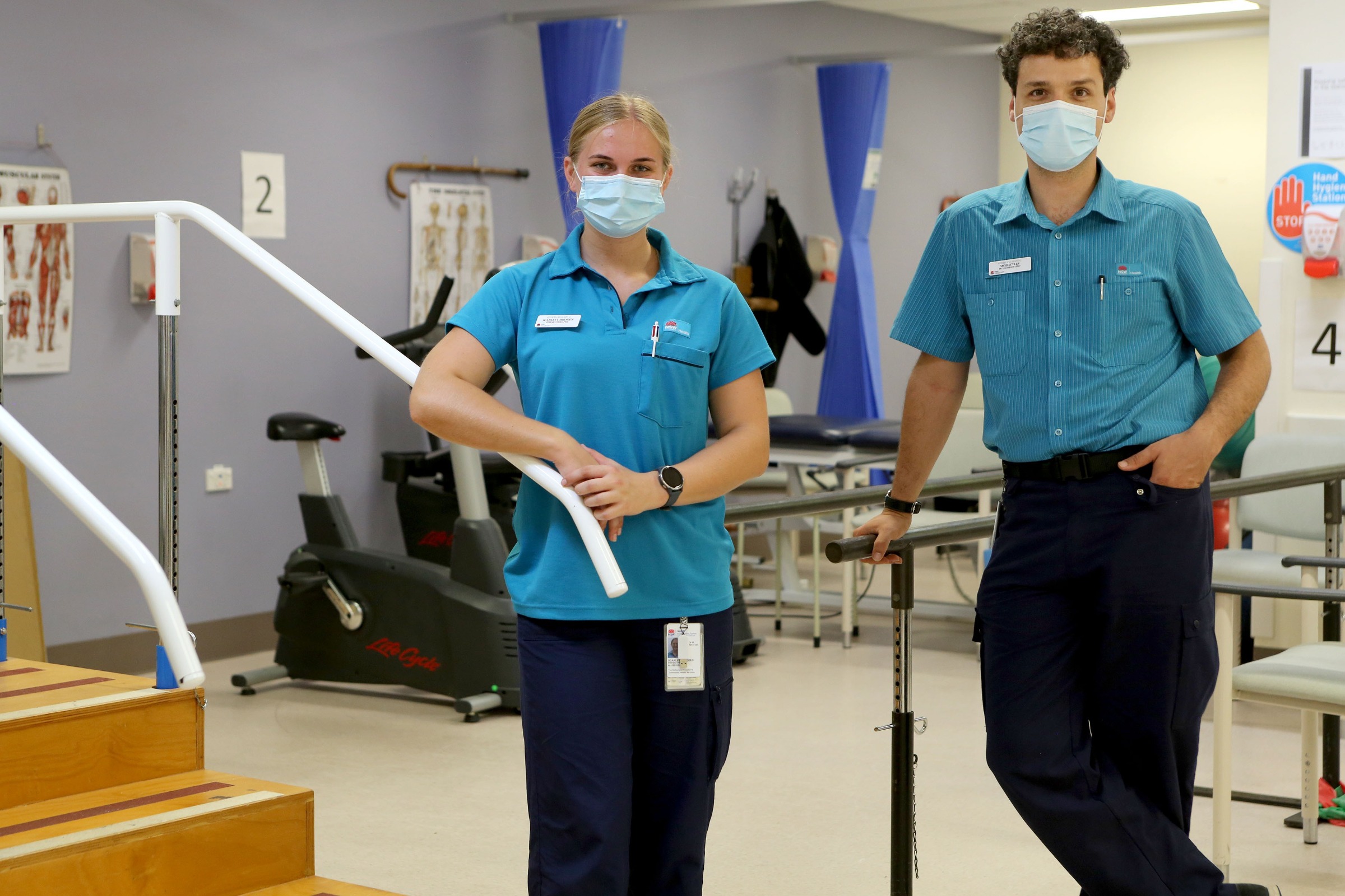 Two physiotherapy graduates standing next to one another