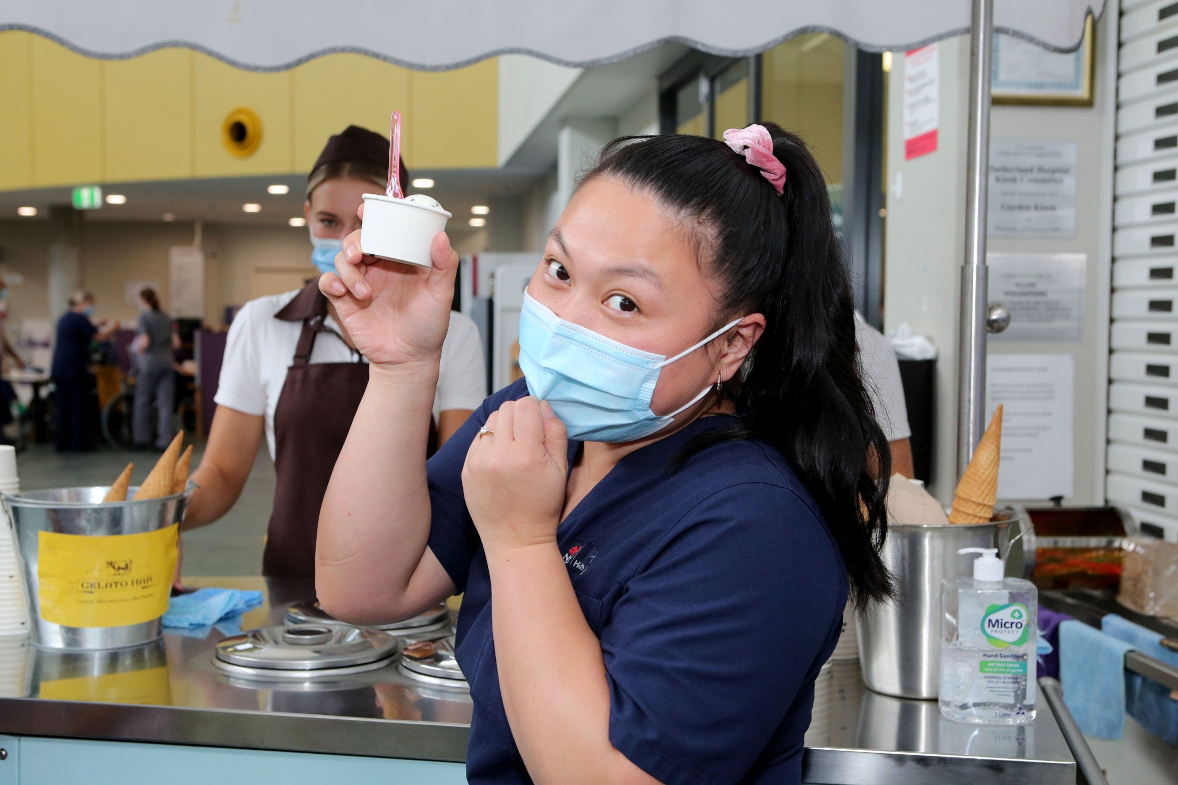 Staff member holding a gelato 