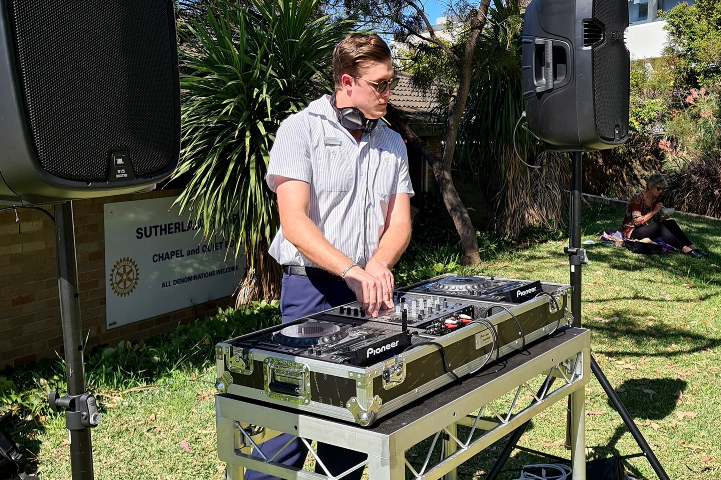 DJ Andrew Nielsen playing music for staff at a music on the lawn event