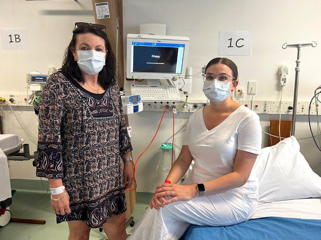 Mother and daughter in hospital ward 