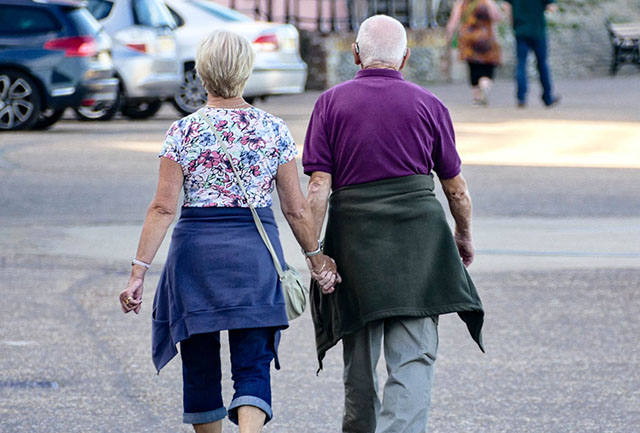 Older couple walking for fitness.