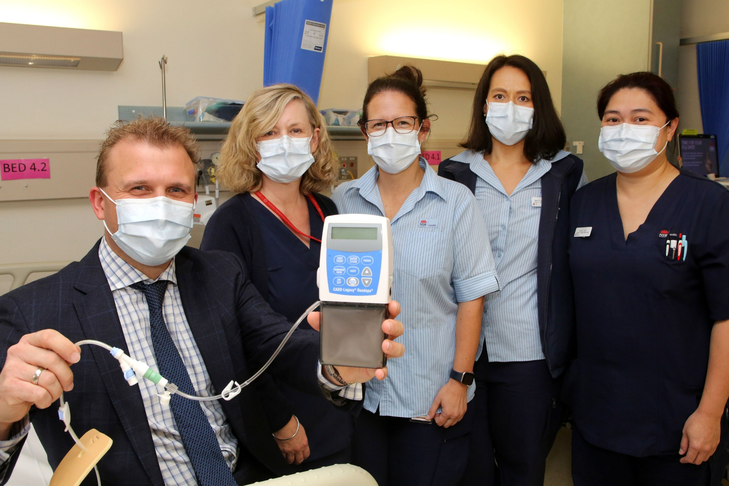 The Movement Disorder Clinic team with an infusion pump