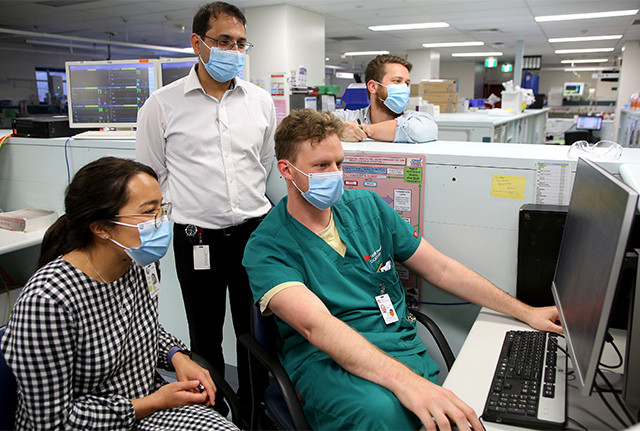 Four doctors around a computer