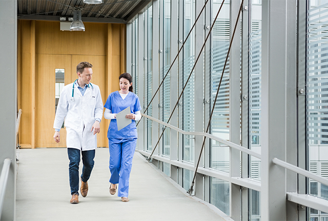 Two medical staff walking in corridor