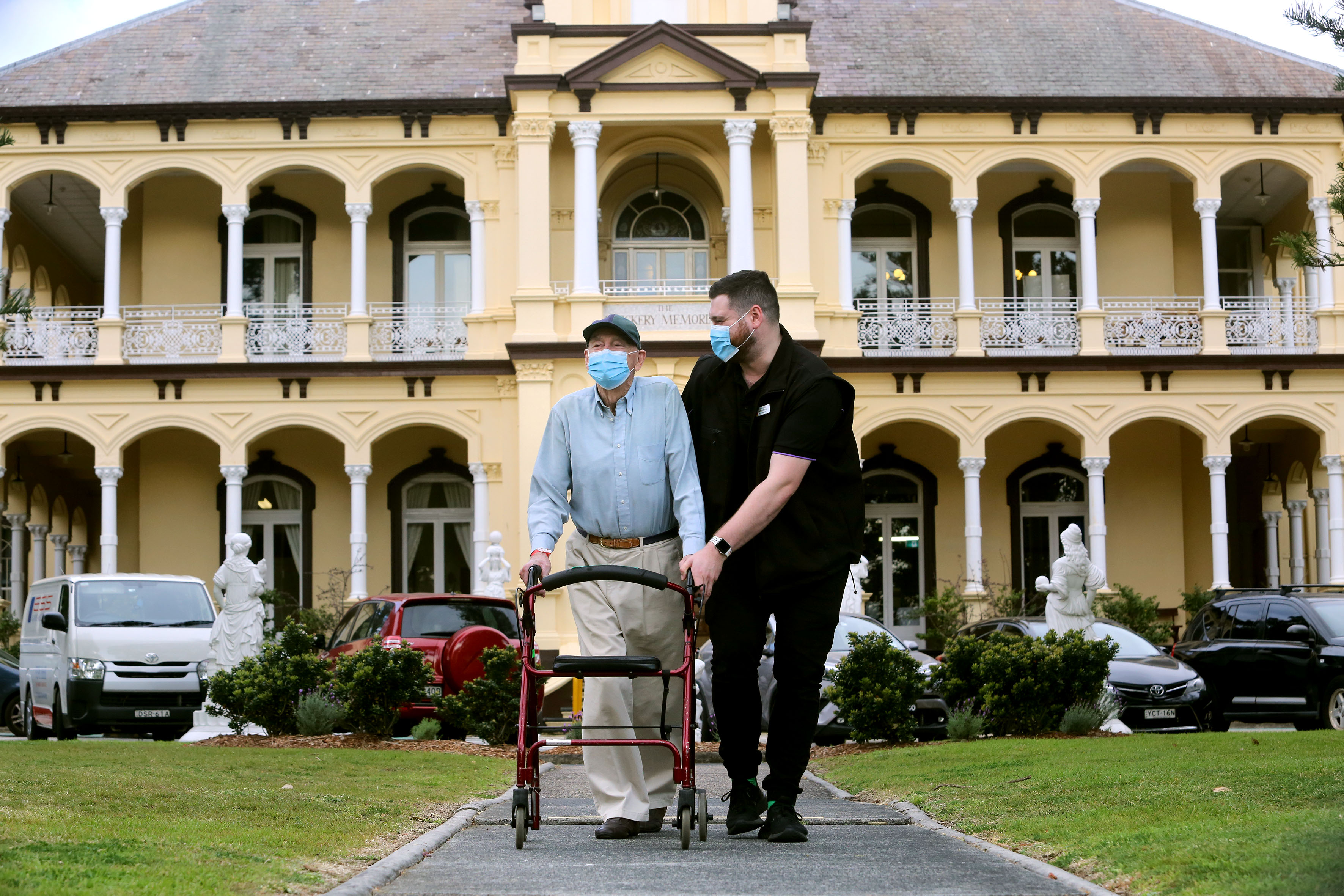 Older gentleman with wheeler accompanied by nurse 