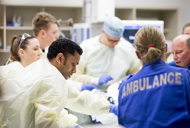 Trauma healthcare staff surrounding patient