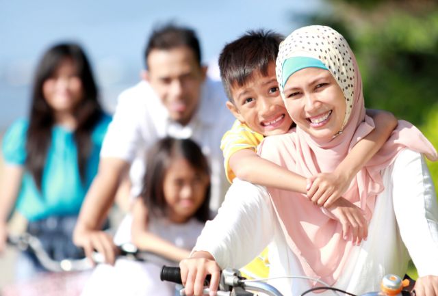 A multicultural family riding bikes