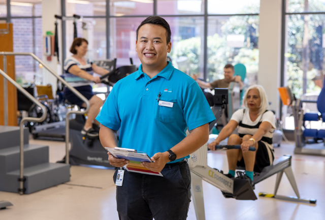 Allied health physiotherapist smiling in a rehab facility