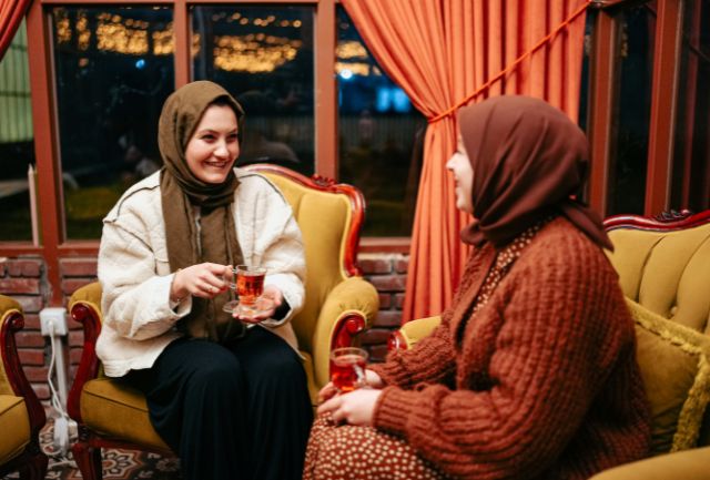 men wearing the hijab having coffee together