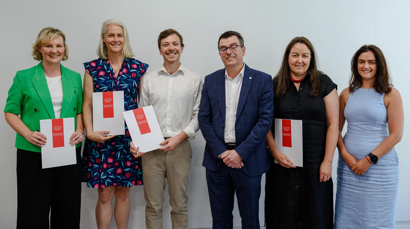 Group of six people holding certificates