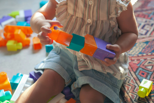 Toddler playing with building blocks