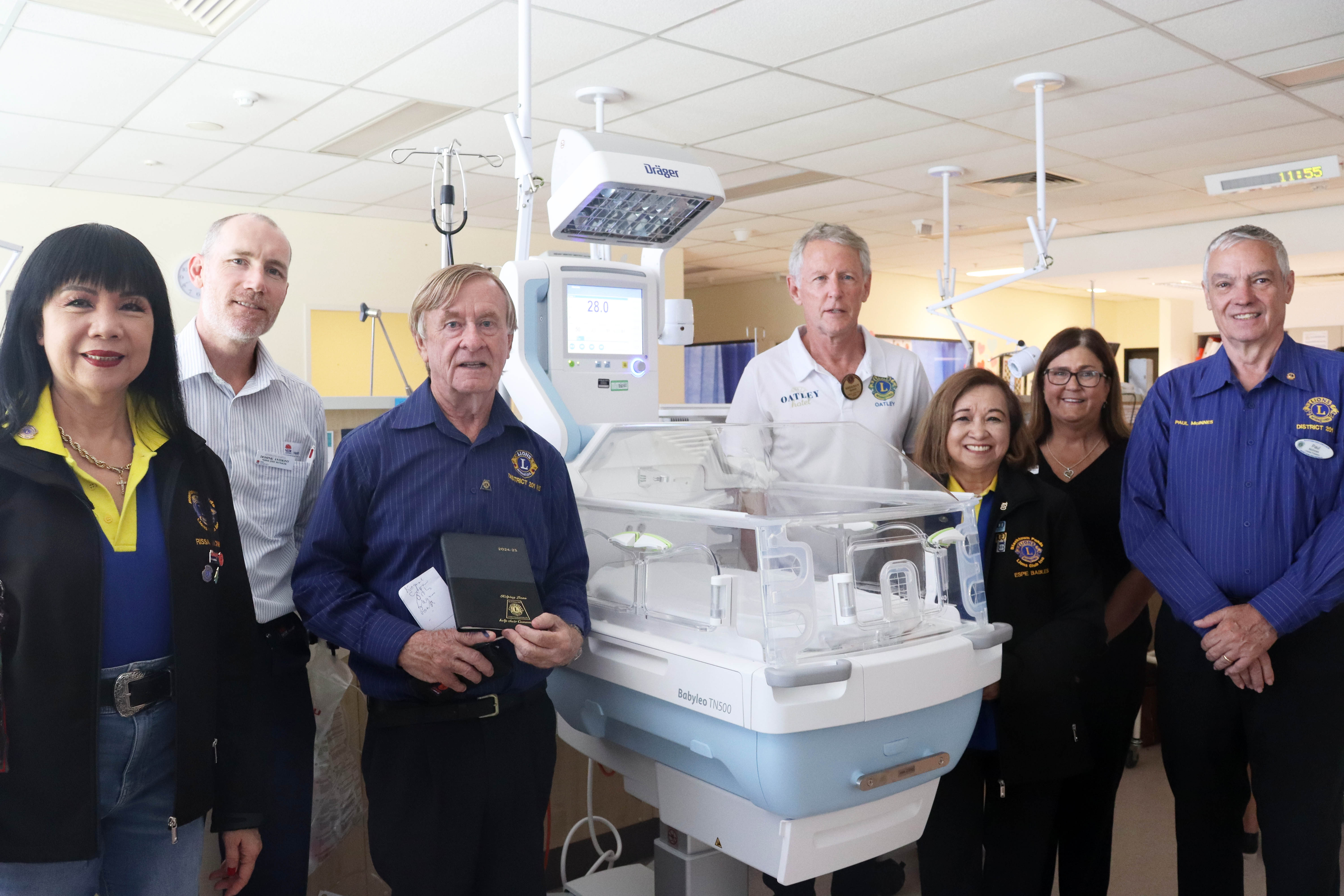 Members of the Lions Club with donated incubator