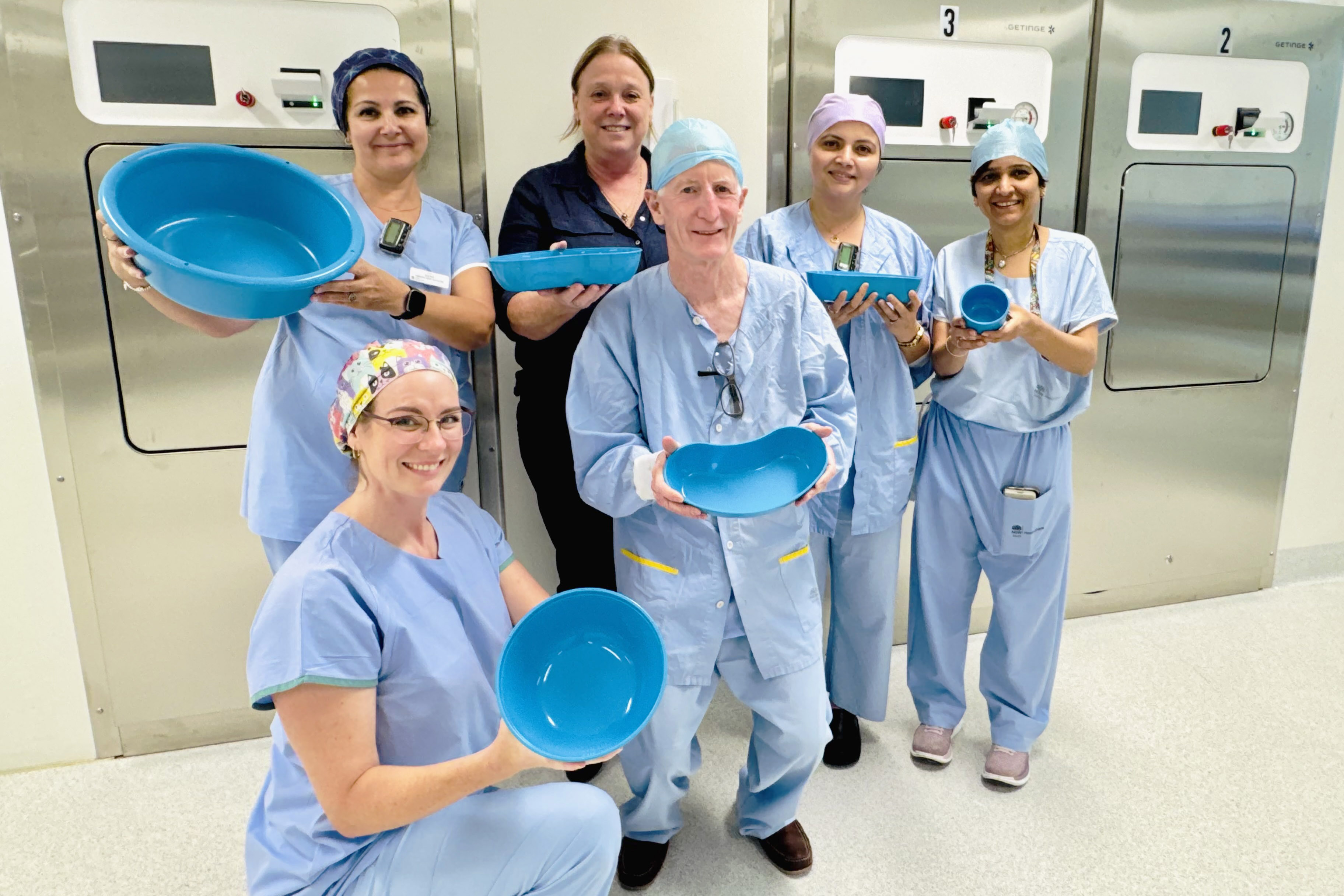 Group of operating theatre staff holding holloware products