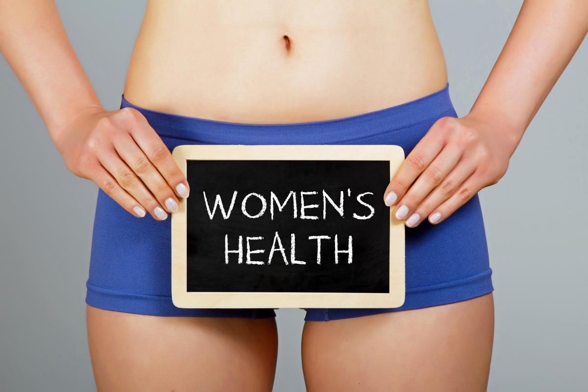 Woman holding sign saying "women's health"