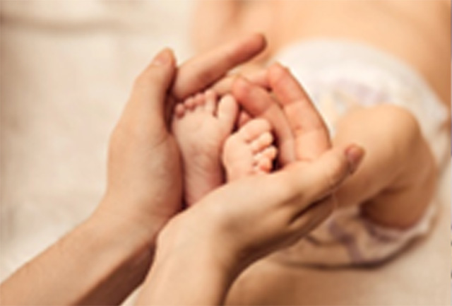 Hands holding feet
