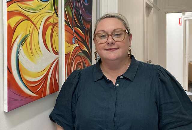 Woman in glasses standing in a hall