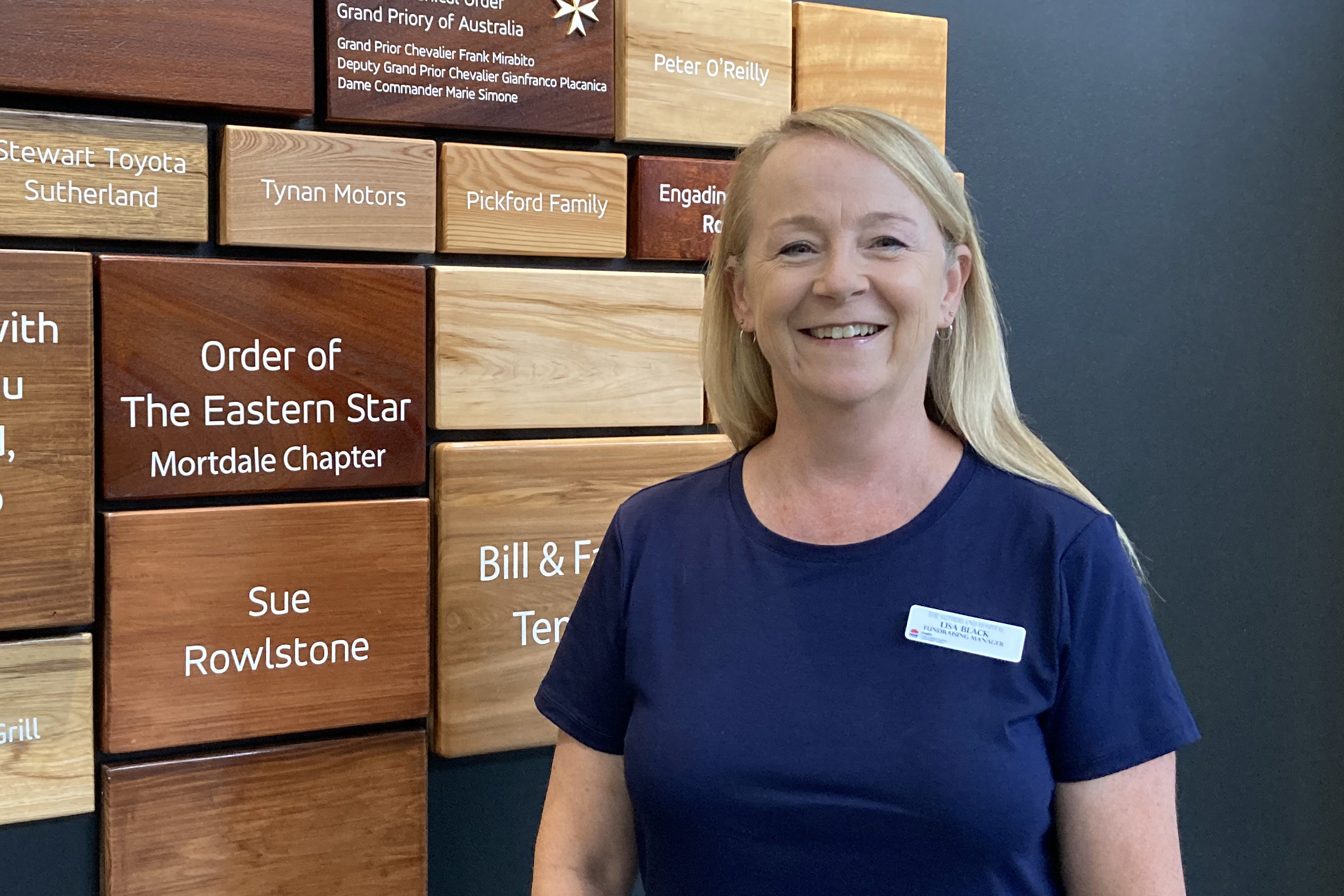 Woman standing in front of charity board