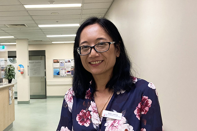 Woman standing in hallway of healthcare facility