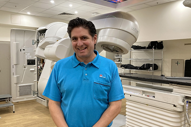 Gentleman standing in front of radiation machine
